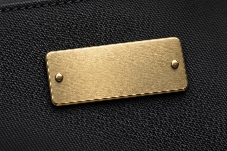 Metal label — logo technique at INEO bag factory